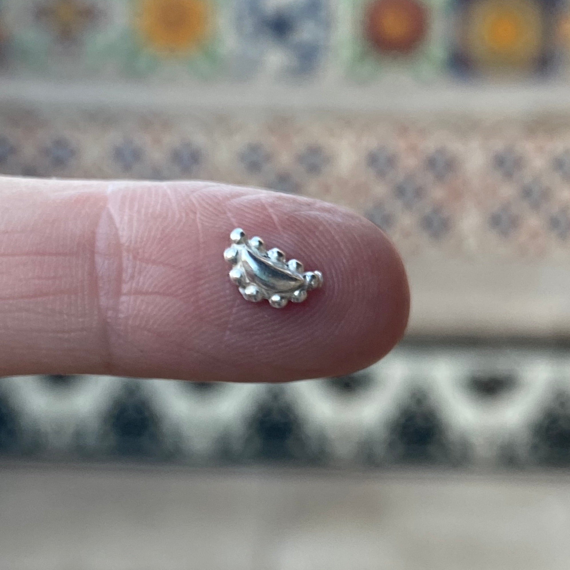 cast silver bead embellishment on finger